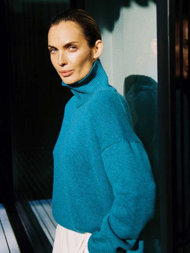 woman in turtleneck cashmere sweater in aquamarine